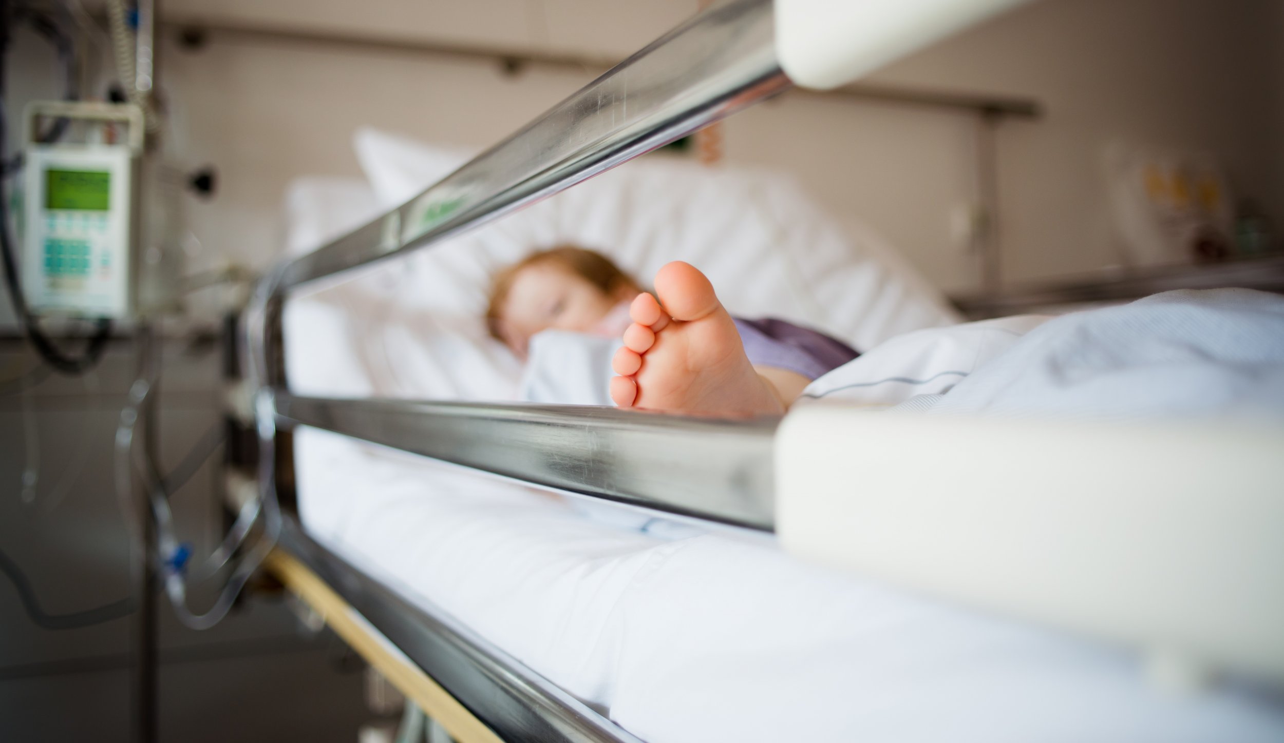 A child resting in a hospital bed